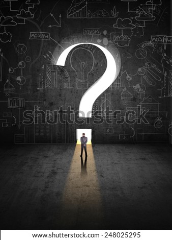 businessman  against black wall with question mark hole