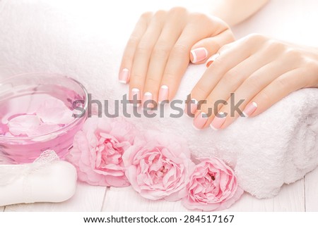 french manicure with rose flowers. spa