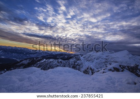 Sunset in the snowy Mountains in a spectacular atmosphere. Perfect for backgrounds for your projects, themes and blogs.