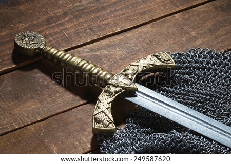 Ancient sword with the bronze handhold on a beautiful background