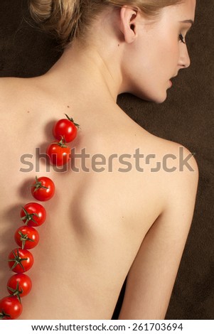 Pretty girl woman model with fruits tomato