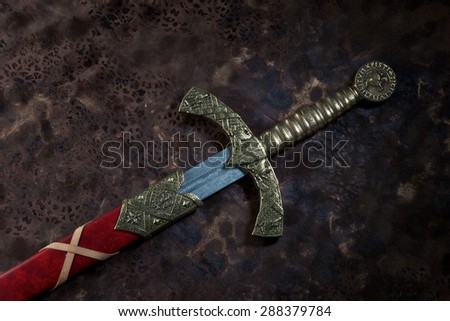 Ancient sword with the bronze hand holdon a beautiful background