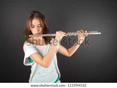 young beautiful girl playing side Flute