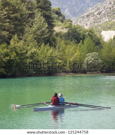 Crew rowing team on lake