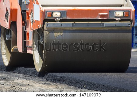 Road-roller pressing new asphalt
