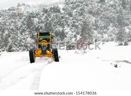 The bulldozer cleans snow on road r cleans snow on road
