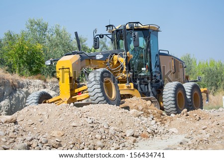 Grader clearing a construction site