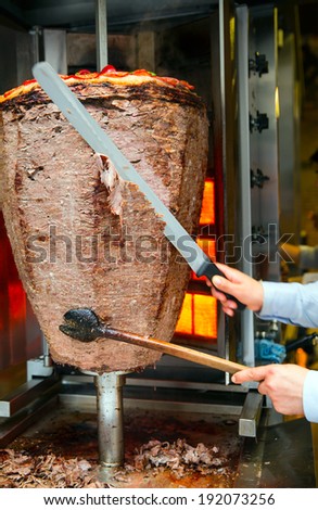 Chef slicing Turkish doner kebab