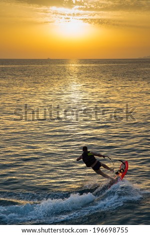 man on jet surf jump on the wave