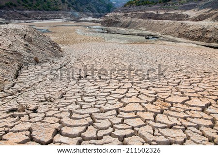 dried river with cracks in the ground