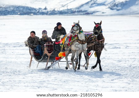 KARS - TURKEY - JANUARY 31: sleigh pulled by a horse in lake frozen cildir. Traditional Turkish winter fun. Cildir lake view at background. Taken on January 31.2014 in Cildir Lake , Kars , Turkey