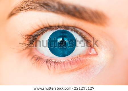 Closeup of human eye with blue pupil.