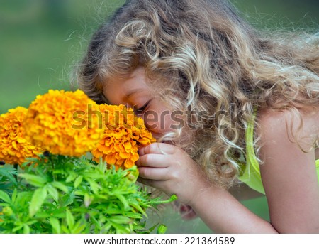 beautiful girl smelling yellow flower
