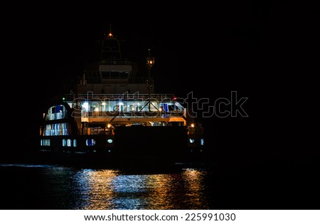 passenger ferry boat in open waters at night