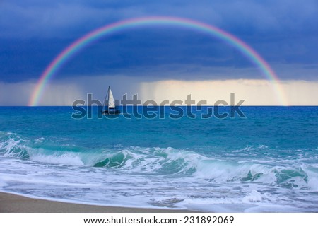 lonely boat against rainbow
