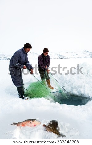 KARS-TURKEY-FEBRUAR Y 01: Fisherman does hole during the annual competition ice fishing, fishing on fishing tackle, February 01, 2014 in Kars, Turkey