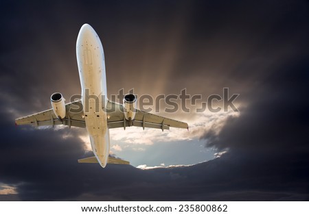 The airplane fly in to gray clouds just before storm
