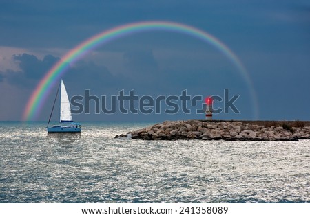 lonely boat against rainbow