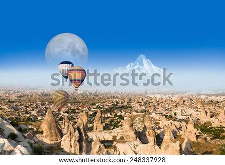 Hot air balloon flying over spectacular Cappadocia .