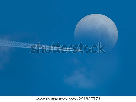 airplane in the clouds with the moon