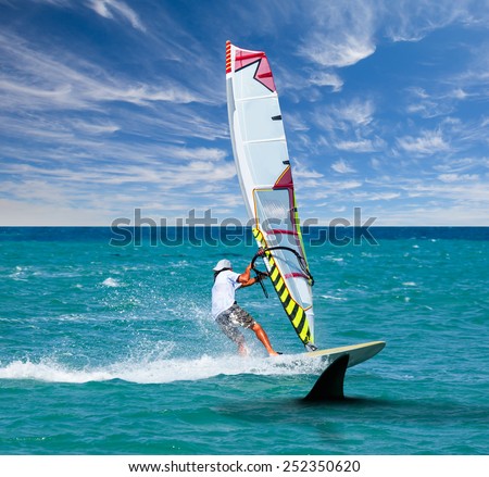 surfing board on wave and hungry shark swimming underwater