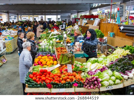 LA SPEZIA, ITALY - MARCH 16, 2015: Sellers offer fruit and vegetables in the city bazaar