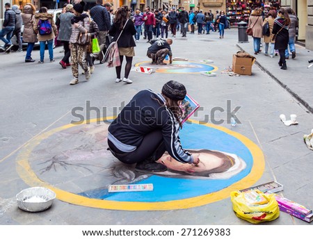FLORENCE, ITALY - MARCH 14, 2015: A street artist draws \
