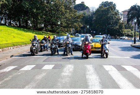 GENOA, ITALY - MARCH 19, 2015: People traveling by a motorbike in genoa