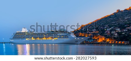 Beautiful white giant luxury cruise ship on stay at Alanya harbor