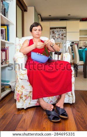 Weary woman cooking vegetables salad