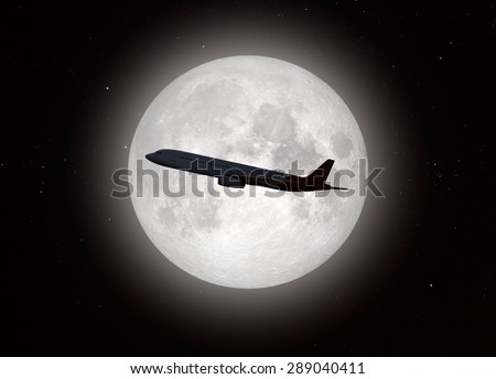 an airplane flying across a full moon \