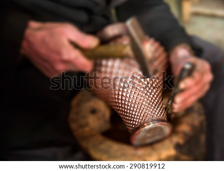 Copper master, Hands detail of craftsman at work  (defocus, blurred)