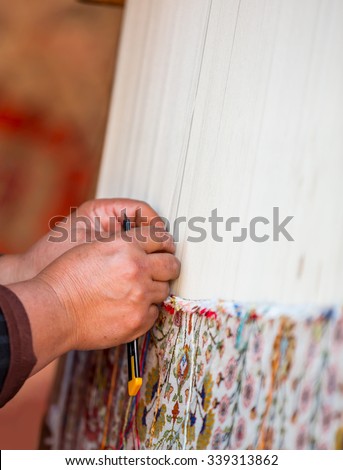 SIDE, TURKEY - NOVEMBER 13, 2015: Woman hands weaving carpet