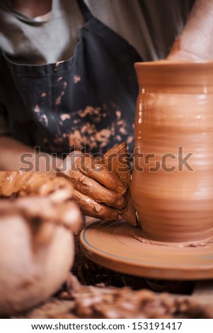 Potter making clay jar