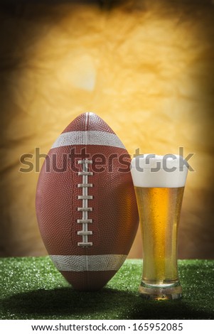 Beer glass and american football ball