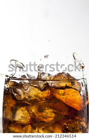 Splashing drink with ice cubes