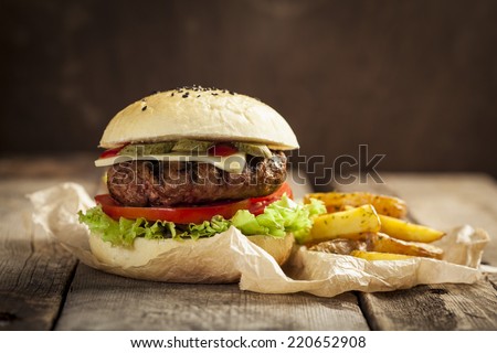 Delicious burger with beef, tomato, cheese and lettuce