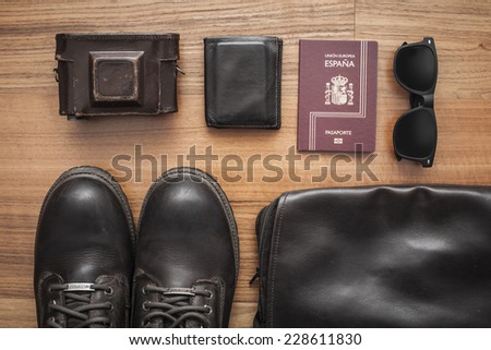 Set with boots, camera, wallet, sunglasses and passport