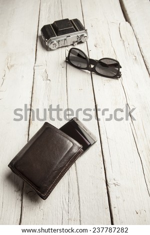 Retro camera, sun glasses, cell phone and wallet