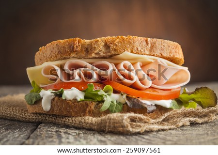 Sandwich with lettuce, tomato, ham and cheese