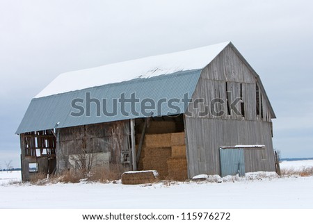 Old snow covered barn in winter setting