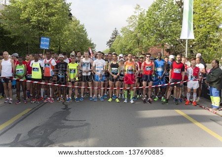 GENEVA - May 5: Unidentified athletes at the start of the 2013 Geneva Marathon for UNICEF, May 5, 2013 in Geneva, Switzerland observe a minutes silence for the victims at the Boston Marathon.