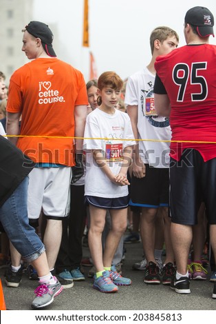 OTTAWA, CANADA - MAY 25, 2014: Unidentified young athletes wait for the start of the Kids Marathon as part of the Tamarack Ottawa Race weekend.