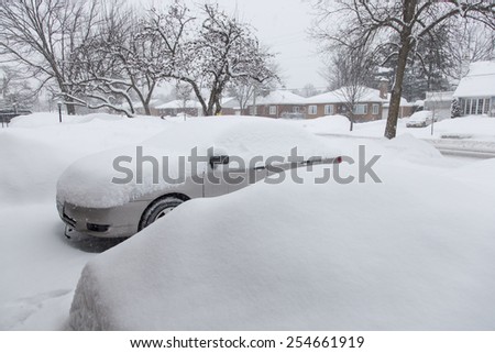 OTTAWA, CANADA FEBRUARY 21, 2015:  A car covered in heavy snow. Reports indicate that Ottawa has had the most days with temperatures below -15 C in 2015 since 1888.
