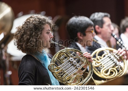 GENEVA, SWITZERLAND MARCH 1, 2015: Musicians playing French Horns in the United Nations Orchestra at a concert at the Victoria Hall commemorating 200 years of Geneva in the Swiss Confederation.
