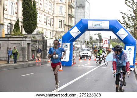 GENEVA, SWITZERLAND - MAY 3, 2015: Ethiopian Alemu Gemechu,  third placed in a time of 2h 11min 47sec, running with just 1 Km to go in the Harmony Geneva marathon for UNICEF.