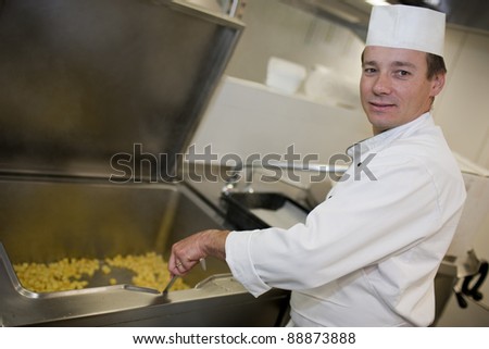 Busy chef preparing meal in restaurant kitchen