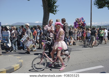 GENEVA, SWITZERLAND - JULY 2 : An unidentified man dressed as a woman on his bicycle while taking part in the Gay Pride Parade 2011, on July 2, 2011 in Geneva, Switzerland.