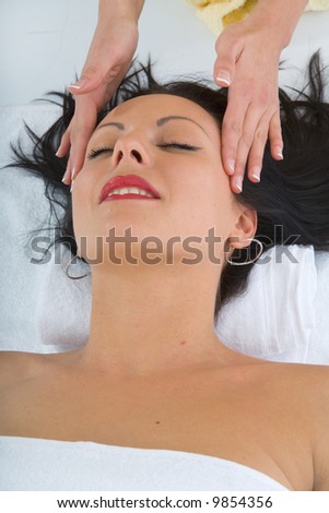 masseuse does relax facial massage to the girl