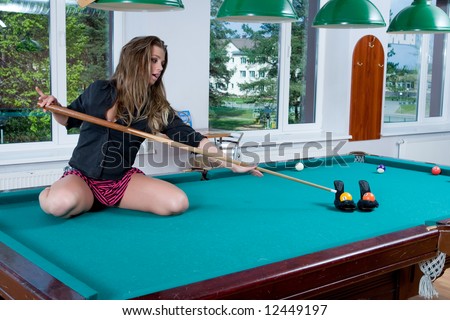Young girl in short skirt playing snooker
